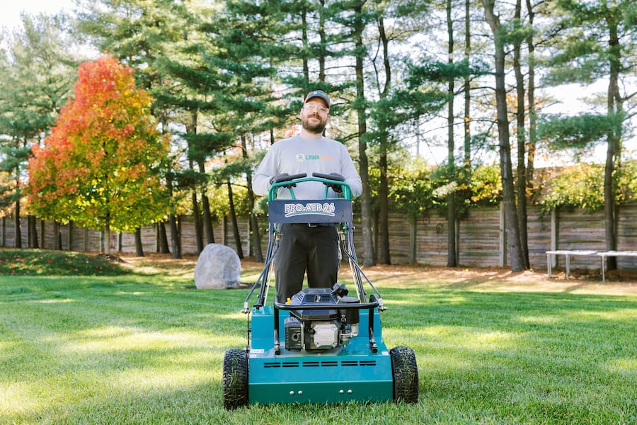 Lawn Squad Employee Mowing Aerating Lawn